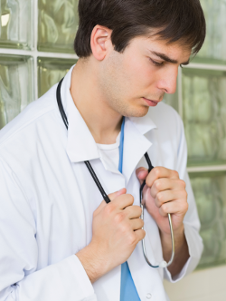 /sebin/v/t/Thoughtful-doctor-in-a-hallway-holding-his-stethoscope-000030493982_scaled.png